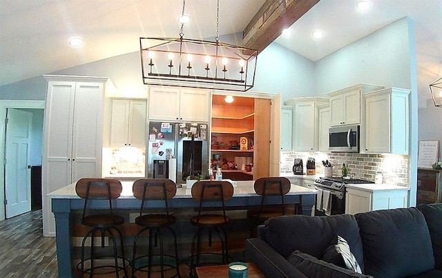 kitchen with light countertops, a breakfast bar area, tasteful backsplash, and stainless steel appliances