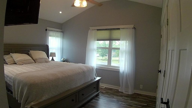 bedroom with dark wood finished floors, multiple windows, baseboards, and vaulted ceiling