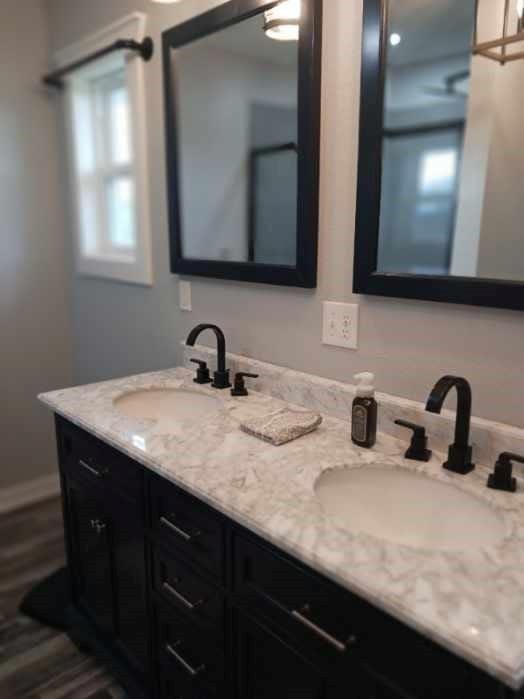 full bath featuring double vanity and a sink