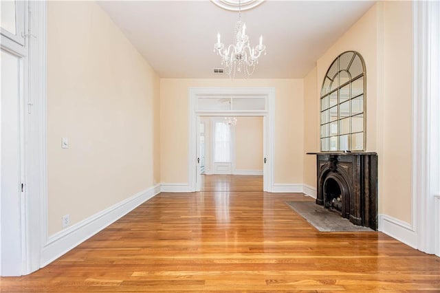 interior space featuring light wood-type flooring and a chandelier