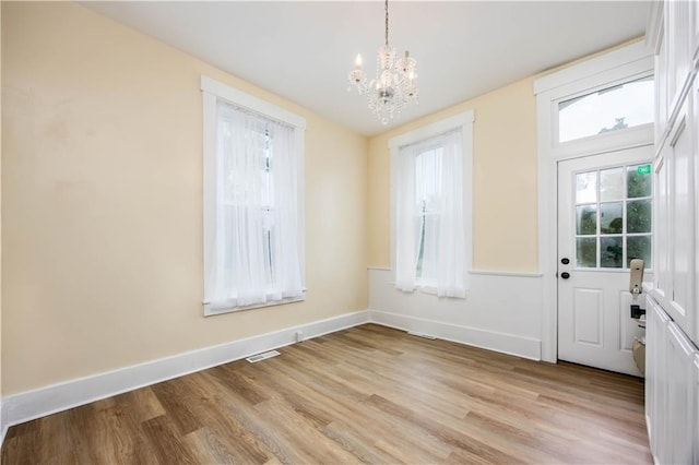 entryway with a chandelier and light wood-type flooring