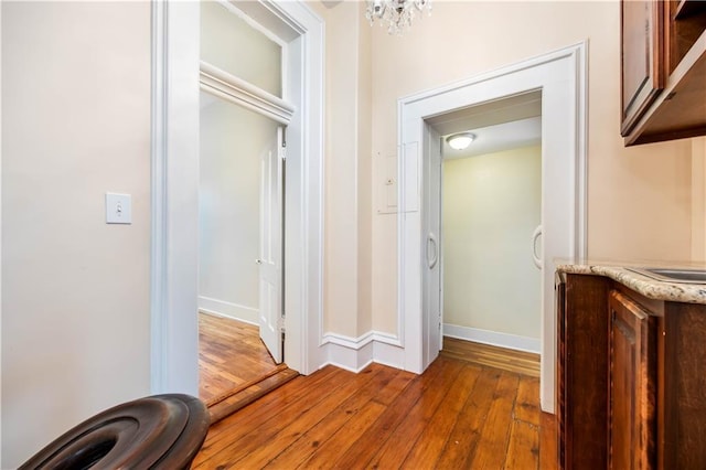 corridor with hardwood / wood-style floors