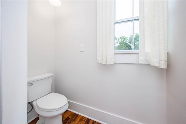 bathroom featuring hardwood / wood-style floors and toilet