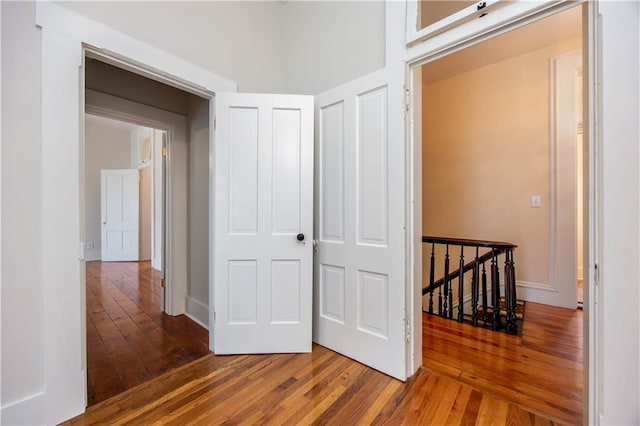 corridor with hardwood / wood-style floors