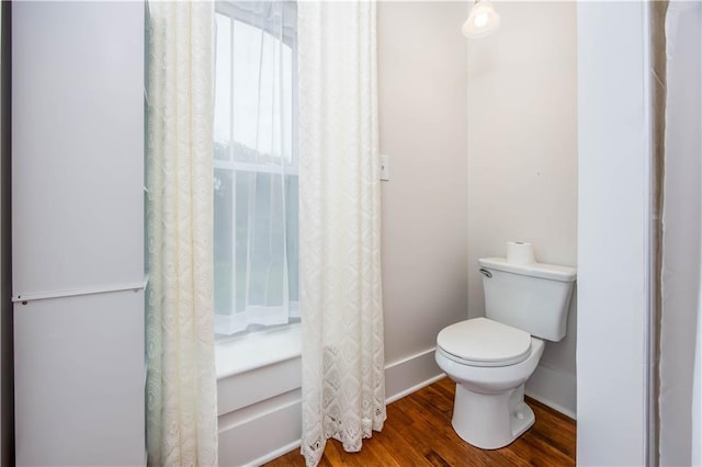 bathroom with wood-type flooring and toilet