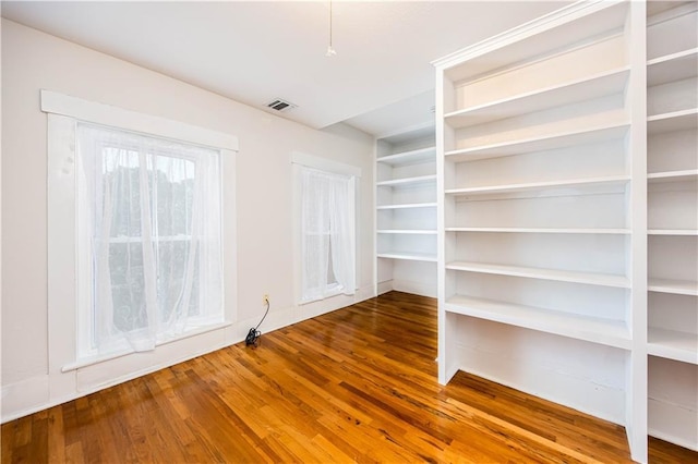 spare room featuring wood-type flooring