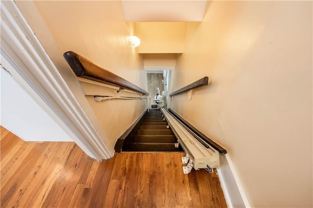 stairway with hardwood / wood-style flooring