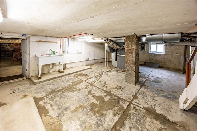 basement with heating unit and sink