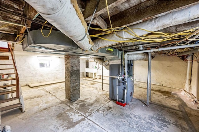 basement featuring heating unit and sink