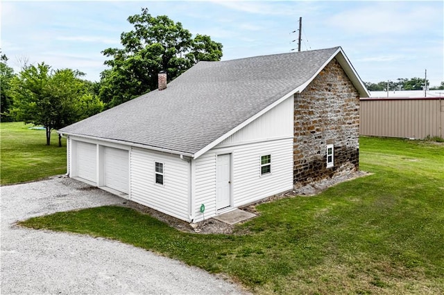 garage featuring a lawn