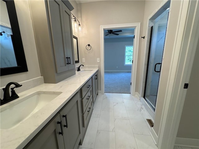 bathroom featuring ceiling fan, vanity, and a shower with shower door