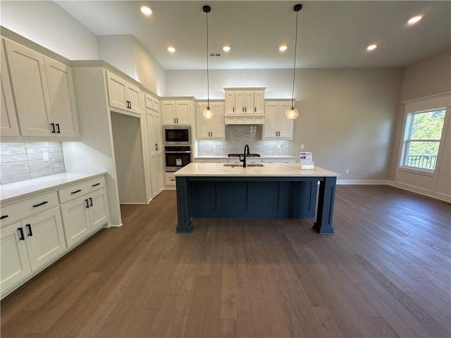 kitchen featuring stainless steel appliances, dark hardwood / wood-style floors, hanging light fixtures, and sink