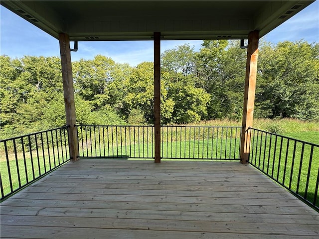 wooden terrace featuring a yard