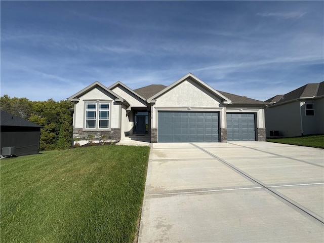 craftsman-style house featuring stucco siding, a garage, stone siding, driveway, and a front lawn