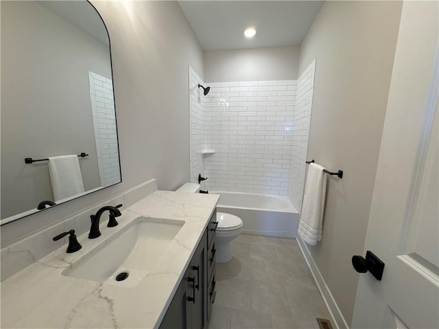 full bathroom featuring vanity, tiled shower / bath, and toilet