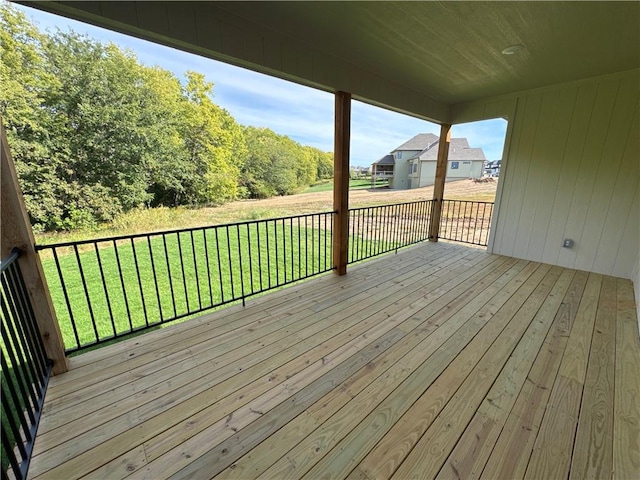 wooden terrace featuring a lawn