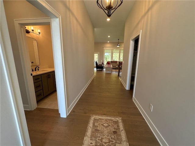 hall featuring light hardwood / wood-style flooring and a notable chandelier