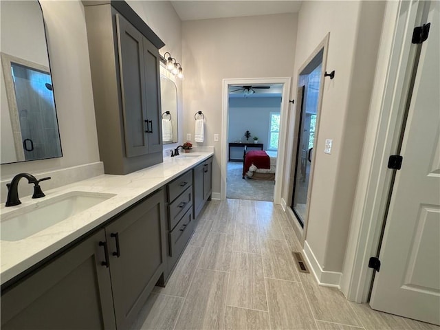 bathroom with walk in shower, vanity, and ceiling fan