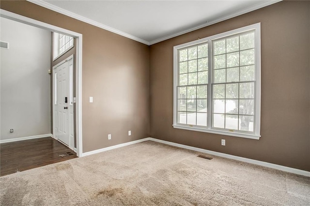 spare room with dark carpet and ornamental molding