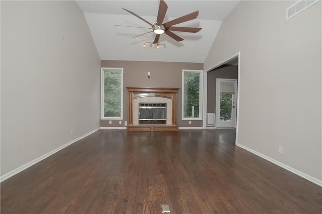 unfurnished living room with a fireplace, dark hardwood / wood-style flooring, vaulted ceiling, and ceiling fan