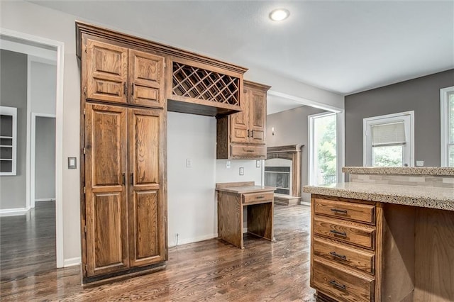 kitchen featuring dark hardwood / wood-style floors and light stone counters