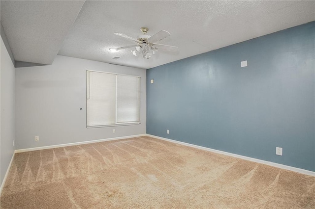 spare room featuring ceiling fan, carpet floors, and a textured ceiling