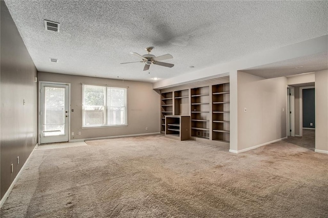 unfurnished living room featuring ceiling fan, light colored carpet, and a textured ceiling