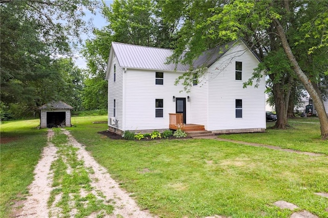 view of front of home with a front lawn and a storage unit