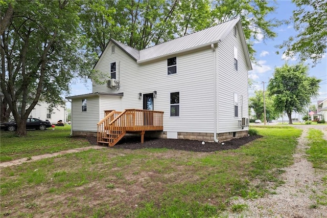 back of property featuring central air condition unit, a yard, and a deck