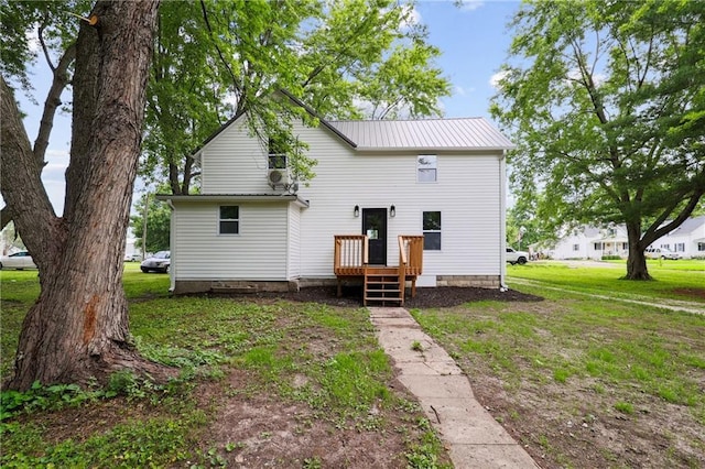 rear view of property featuring a yard