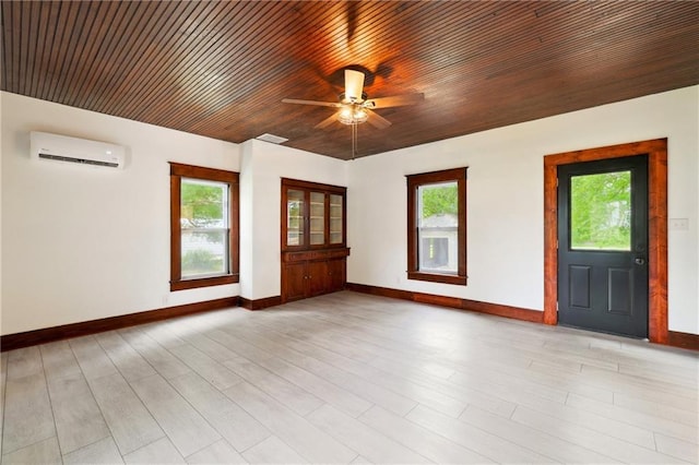 empty room featuring ceiling fan, an AC wall unit, and wood ceiling