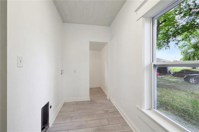 washroom featuring electric dryer hookup, plenty of natural light, and light hardwood / wood-style floors