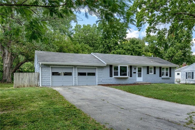 single story home featuring a garage and a front yard