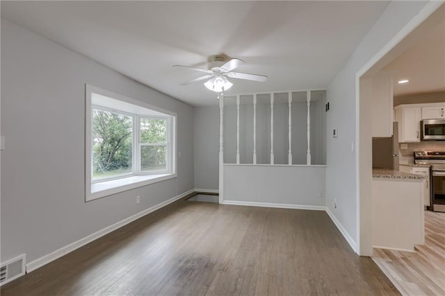 unfurnished room with light hardwood / wood-style floors and ceiling fan