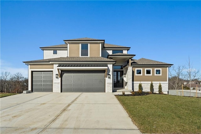 prairie-style home featuring a front yard and a garage