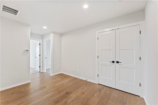 unfurnished room with light hardwood / wood-style floors