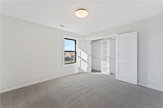 unfurnished bedroom featuring carpet floors and a closet