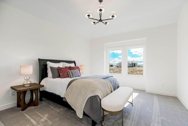 carpeted bedroom with a chandelier