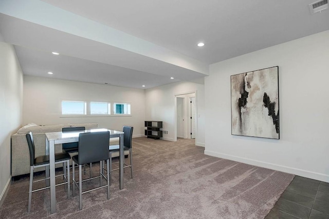 dining area featuring dark colored carpet