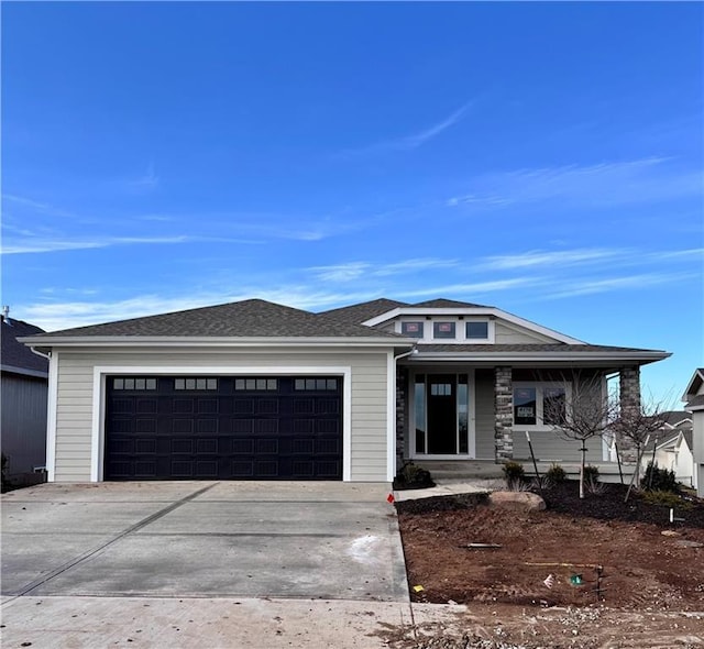 prairie-style house featuring a garage and covered porch