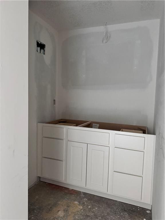 bathroom featuring concrete floors and a textured ceiling