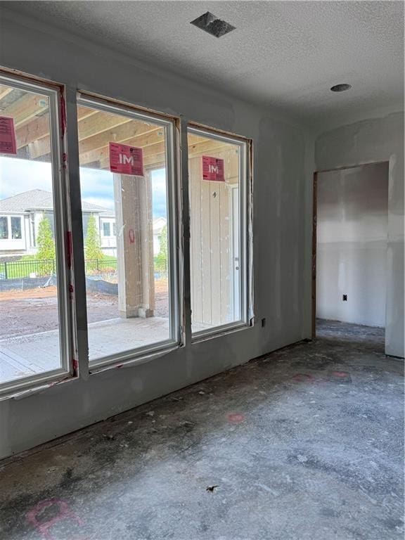 empty room featuring concrete flooring and a textured ceiling