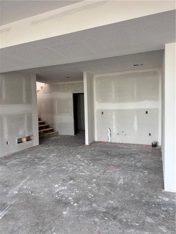 unfurnished living room featuring a textured ceiling