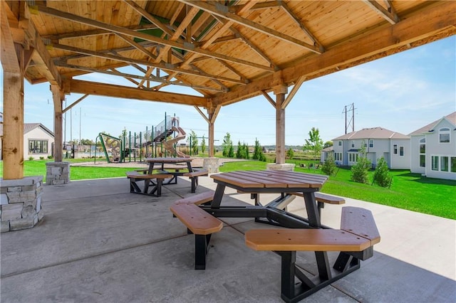 surrounding community featuring a yard, a playground, and a patio area