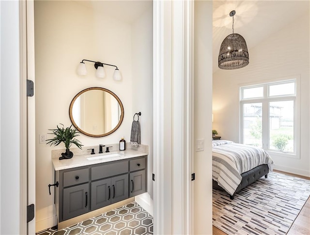 bathroom featuring a chandelier and vanity