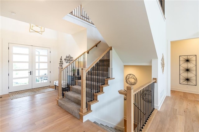 foyer featuring french doors and light hardwood / wood-style floors