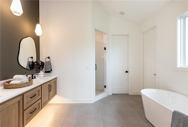 bathroom featuring tile patterned flooring, vanity, a healthy amount of sunlight, and plus walk in shower