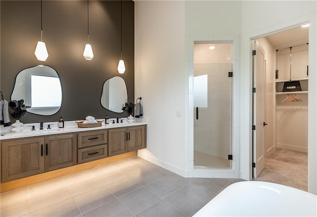 bathroom with tile patterned floors, vanity, and a shower with shower door