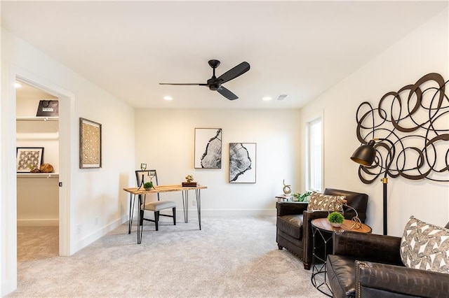 sitting room featuring ceiling fan and light colored carpet