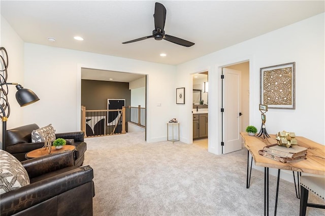 carpeted living room with ceiling fan